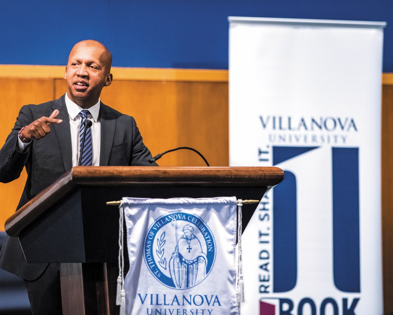 Adela Dwyer-St. Thomas of Villanova Peace Award recipient Bryan Stevenson in a suit speaking at a podium