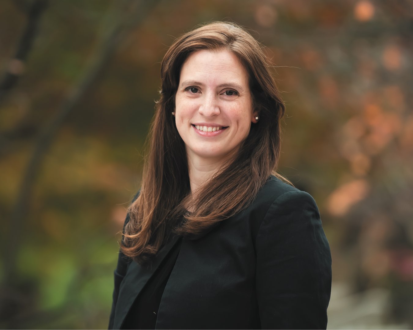 2015 alumna Carla Krystyniak in a black suit jacket