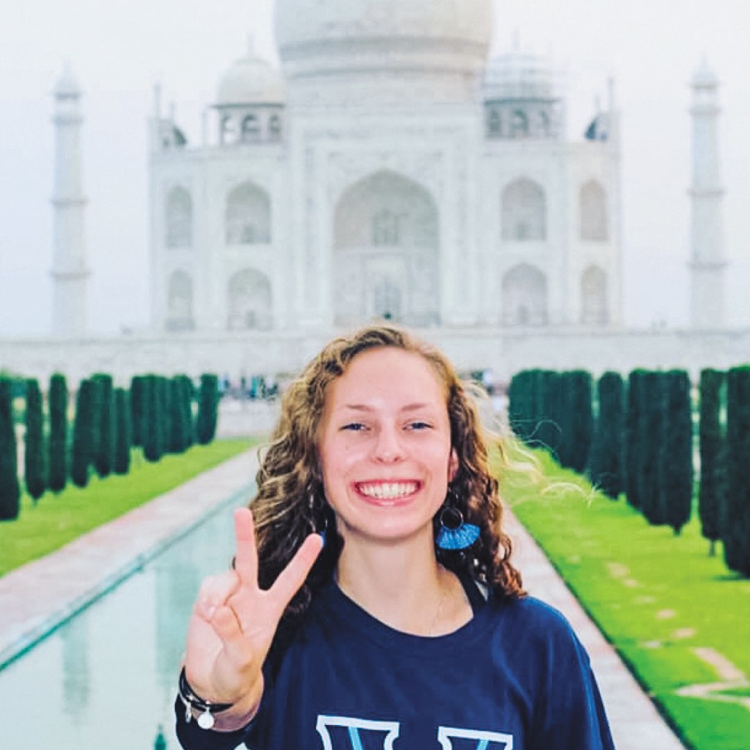 A female Villanova student in a Villanova T-shirt in front of the Taj Mahal in India