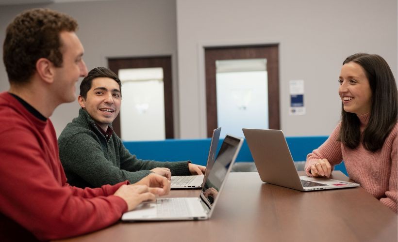 Students and adults networking in the Career Center