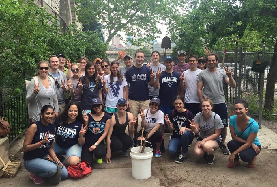 St. Thomas of Villanova Day of Service Group of Villanova alumni with their "V"s up, posing with shovels, buckets and other gardening items