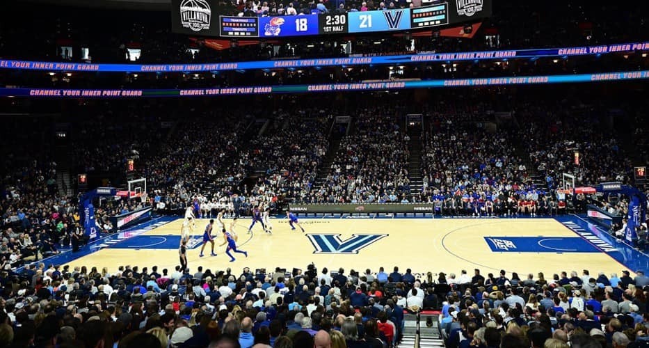 Basketball Wide shot of a basketball arena, filled with fans; the court has a Villanova "V" in the middle