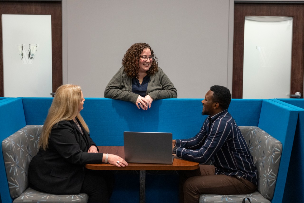 Student and two career managment staff in conversation.