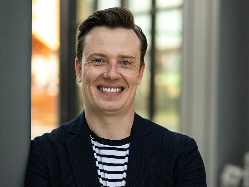 Dieter Bender in a black-and-white shirt and black blazer