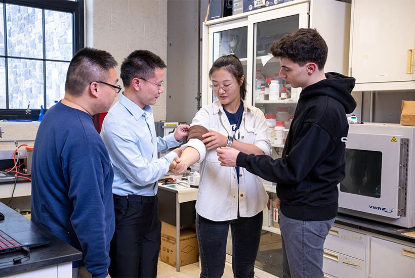 Students working on the Smart Sleeve in a lab