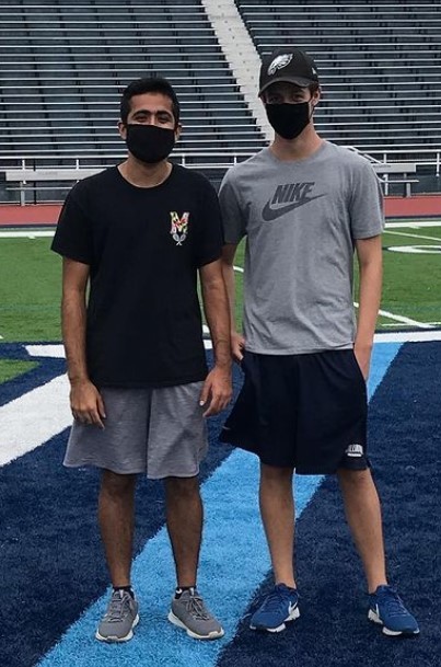 Two male students posing for bocce ball champs photo