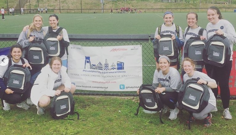 Female students posing for softball champion photo