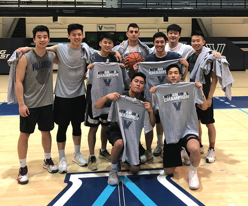 Male students posing for basketball champion photo