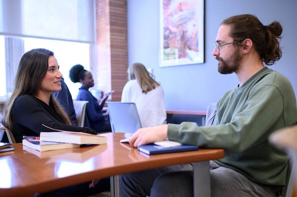 Two students in conversation in the Writing Center.