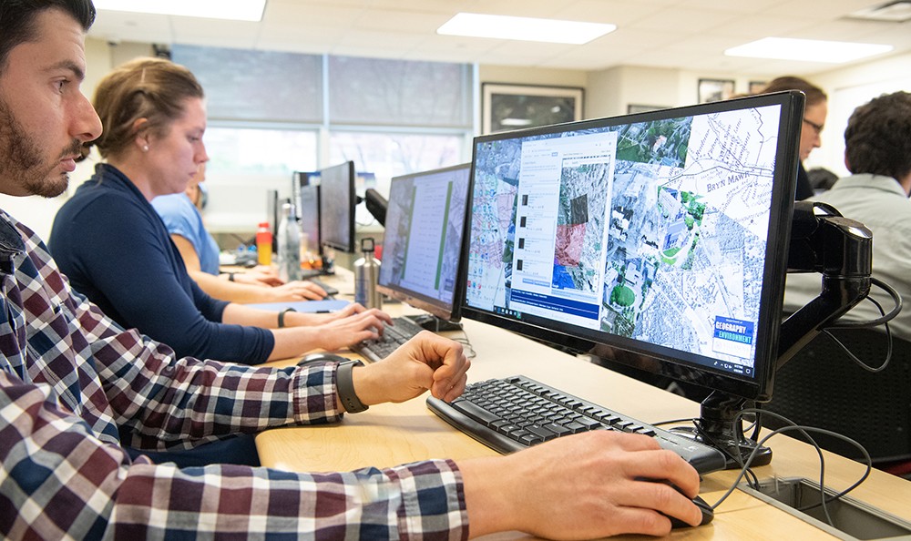 Environmental Science graduate students working with GIS software in computer lab