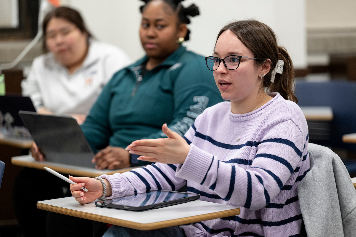 Graduate students seated in a classroom.