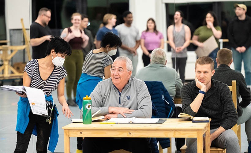 Faculty, staff and students working together during rehearsal