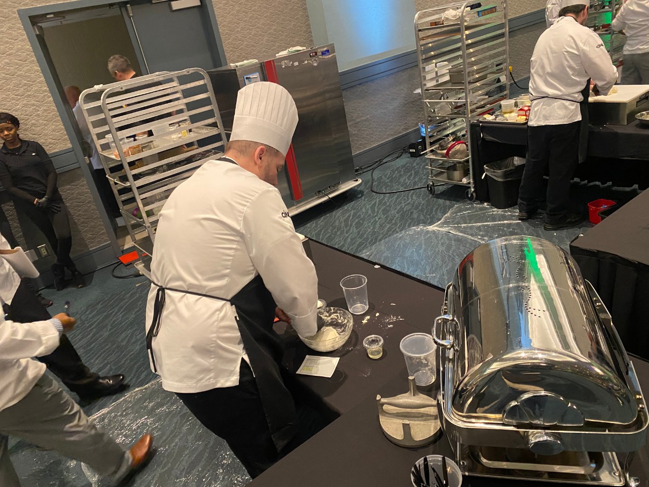 Chef Christopher Wiseley prepares his dish at the 2025 NACUFS Culinary Challenge.