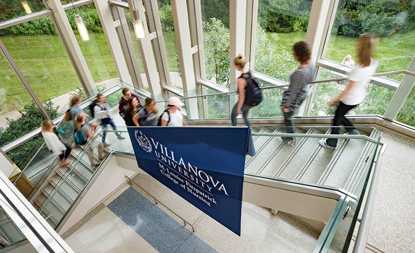 Undergraduate Program Students on the staircase in the main atrium of Driscoll Hall, home of the College of Nursing.