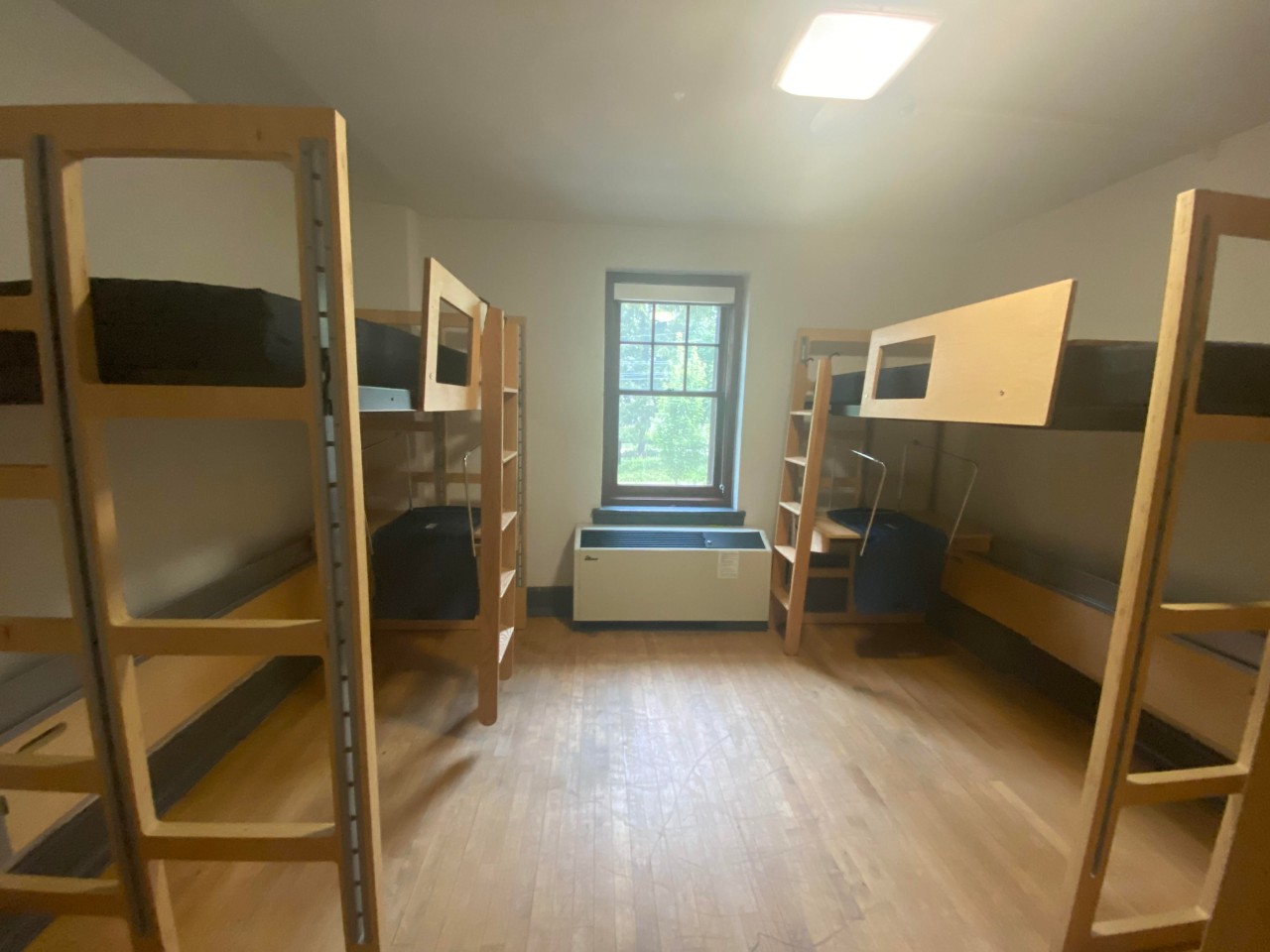 View of bunk beds and a desk in a Fedigan Hall double room.