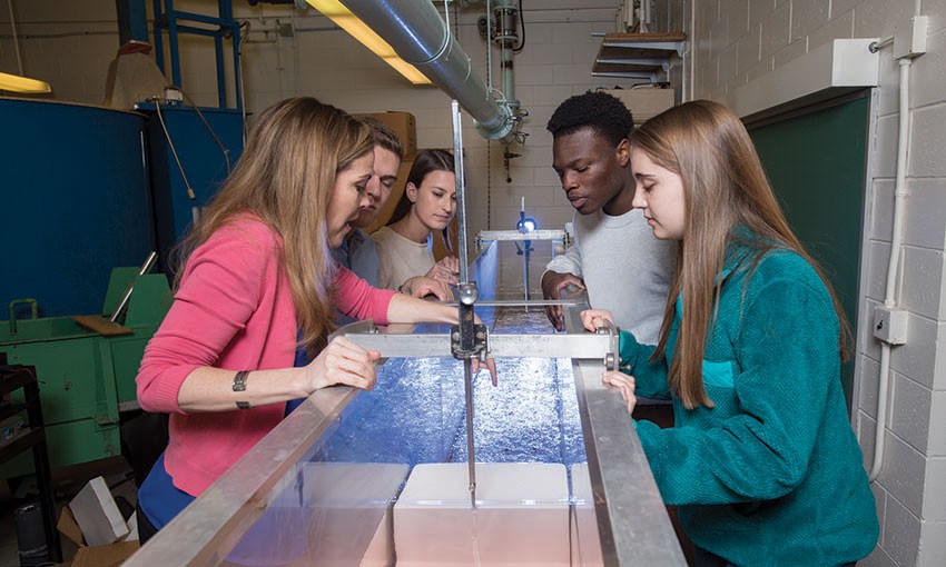 Villanova faculty and students in research facility Villanova faculty member working with students in a hydrology and Hydrolics lab.