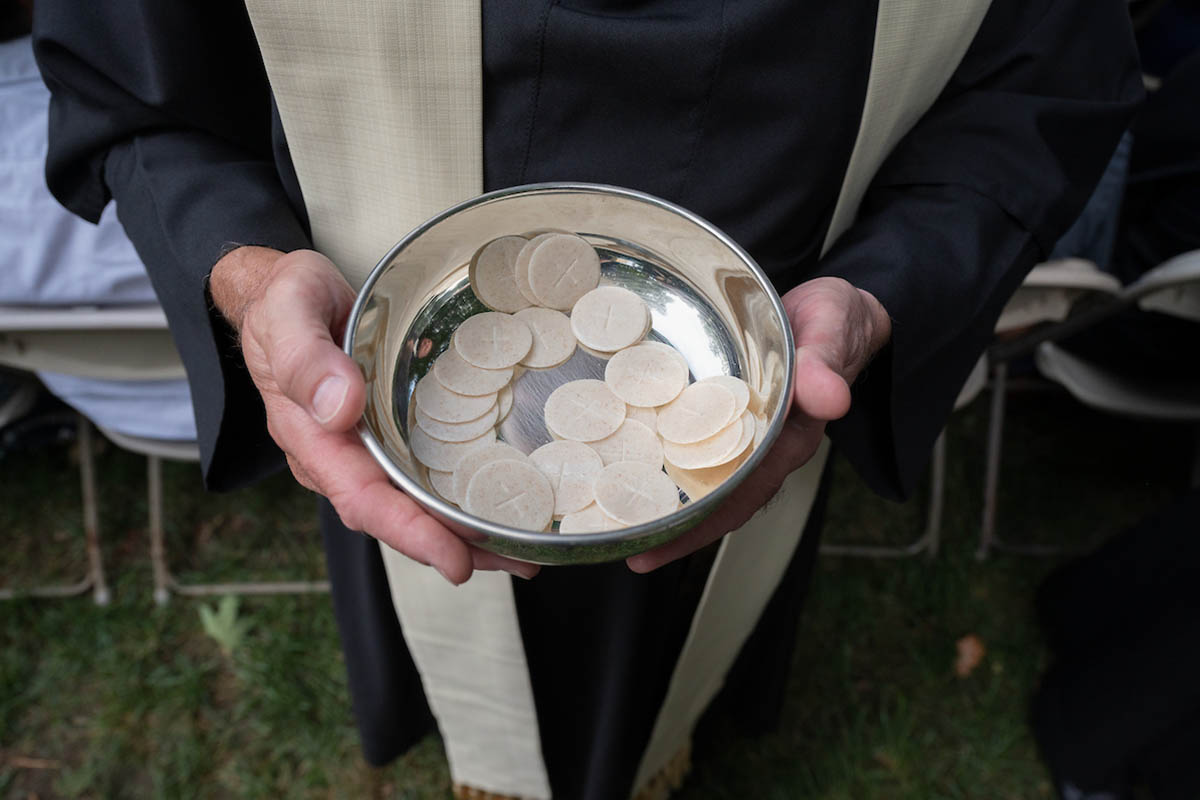 A priest carrying communion