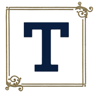 Image of the letter T in a script font with gold filigree surrounding it