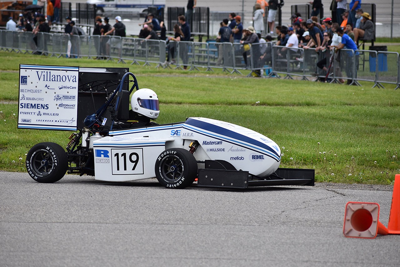 NovaRacing driver with helmet on seated in car No. 119