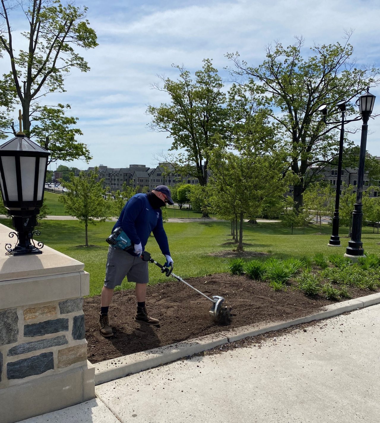 Villanova Grounds crew member weedwacking