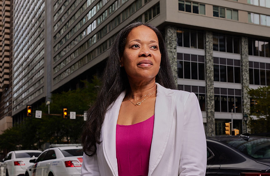 Erica Howard dressed in business attire standing near busy Philadelphia street