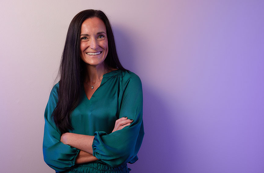 closeup of a smiling Erin Smith standing with her arms crossed 