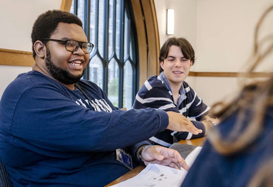 Two students behind the table