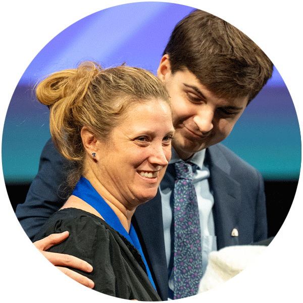 Opus Prize student ambassador Christopher Link putting his arm around Dr. Kristin Schroeder