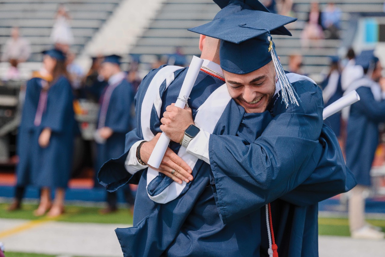 two Villanovans embrace at commencement